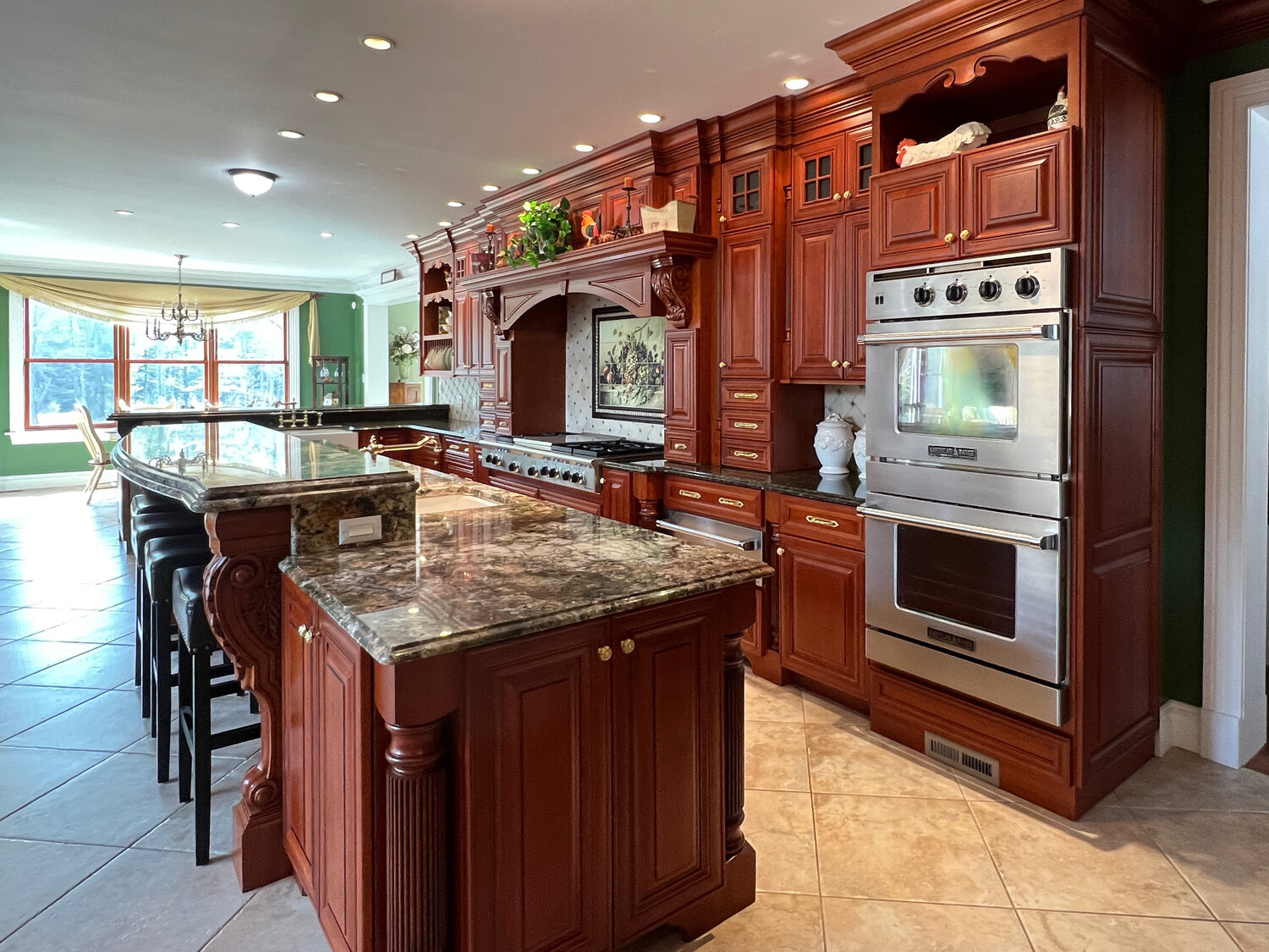 The kitchen has a 60-inch gas cooktop with a grill, plus twin wall ovens...